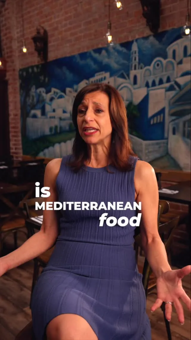 Nicky speaking at George’s, with on-image words about Mediterranean food.
