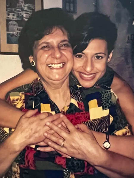 Two women smiling and embracing in a George’s family photograph.